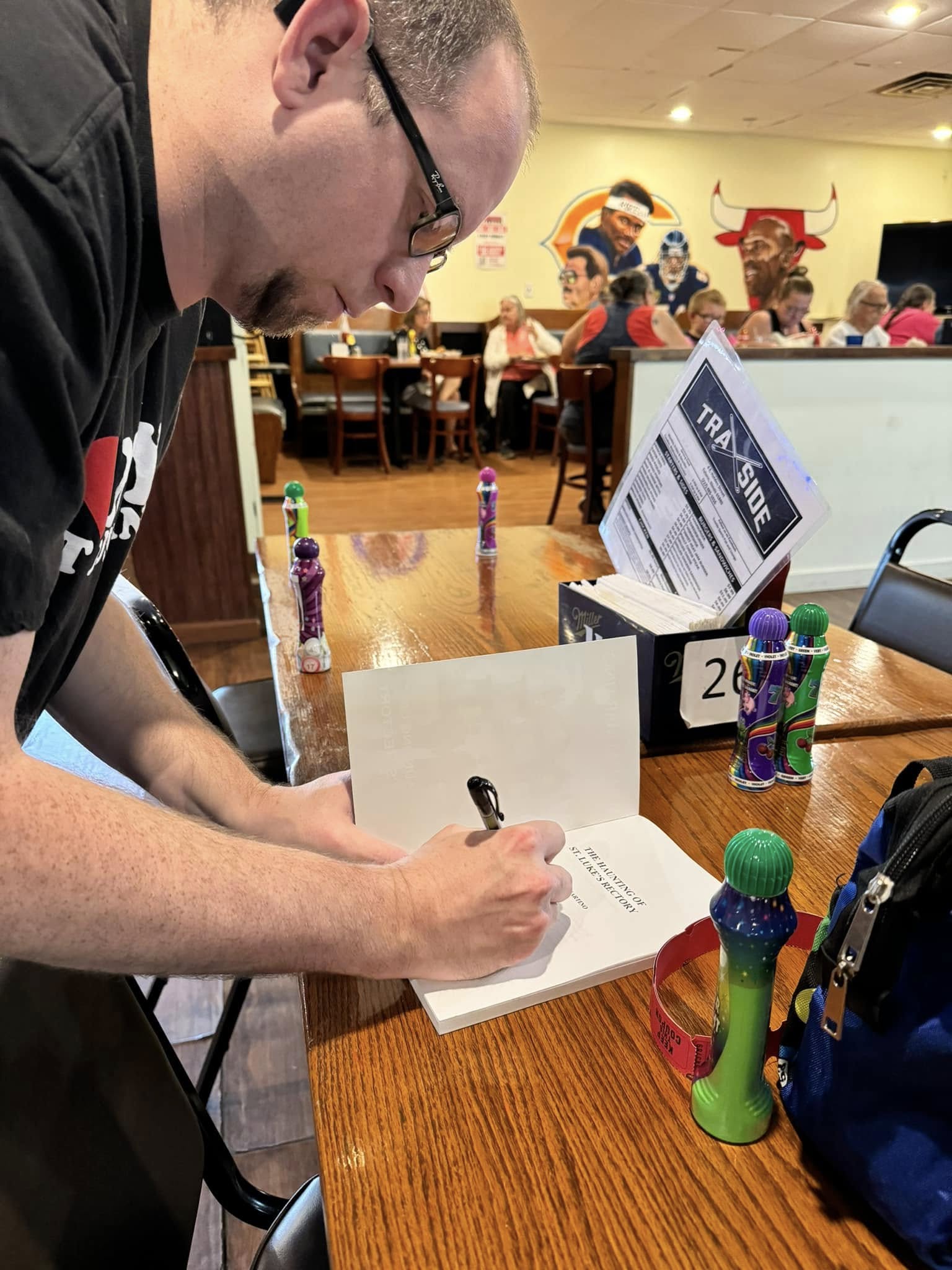 William Martino signing a book